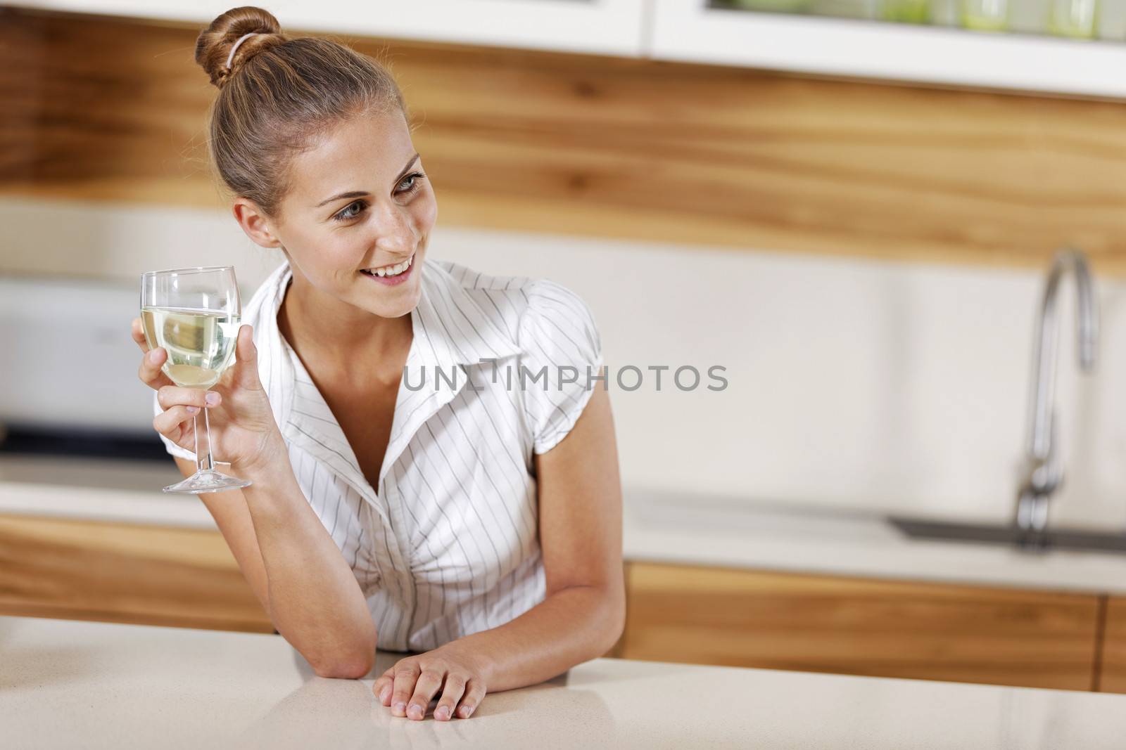 Young business woman relaxing at home with a glass of wine.
