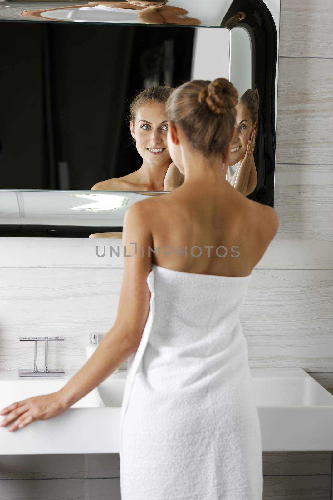 Attractive young woman in her bathroom getting ready.