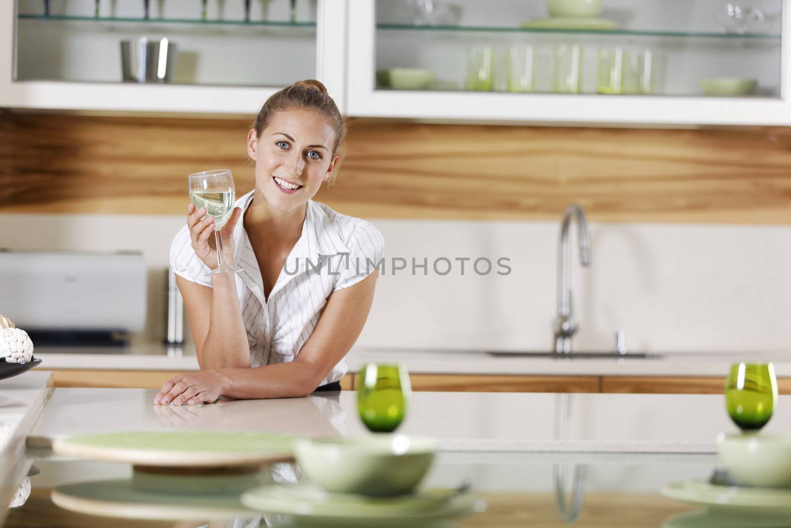 Young business woman relaxing at home with a glass of wine.