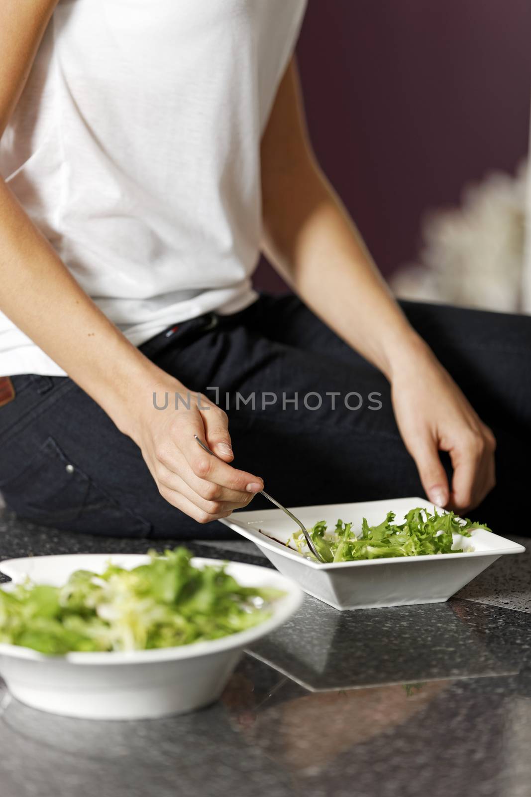 Fresh green salad being prepared in a kitchen