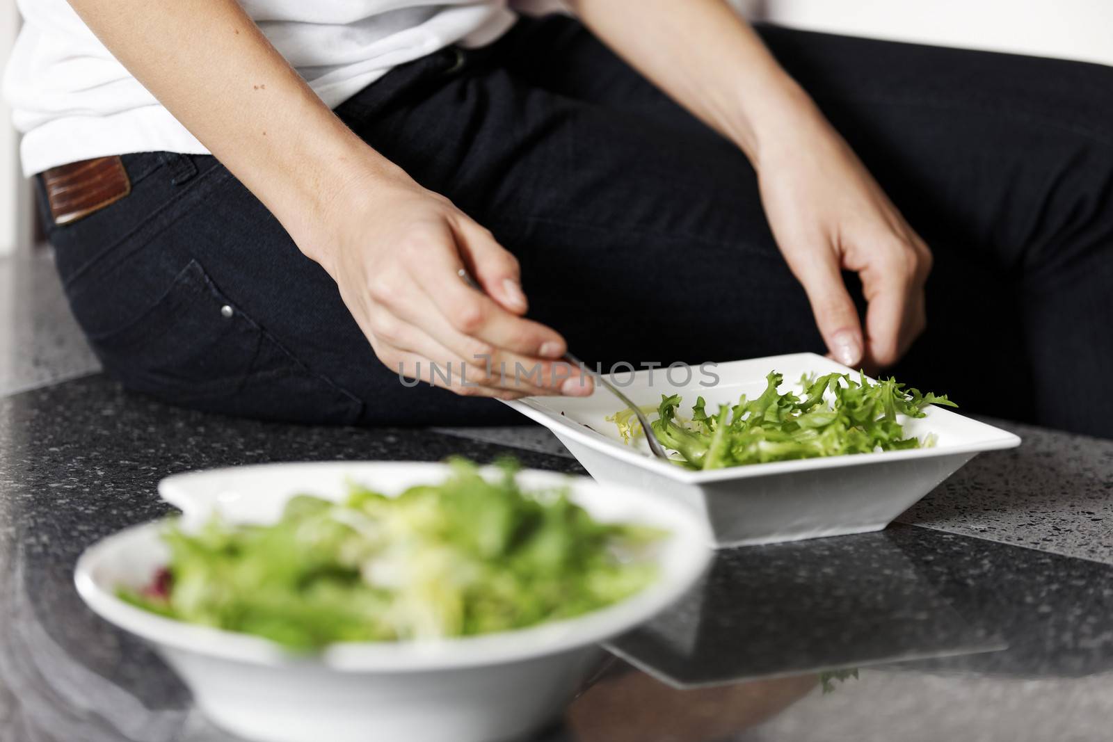 Woman preparing salad by studiofi