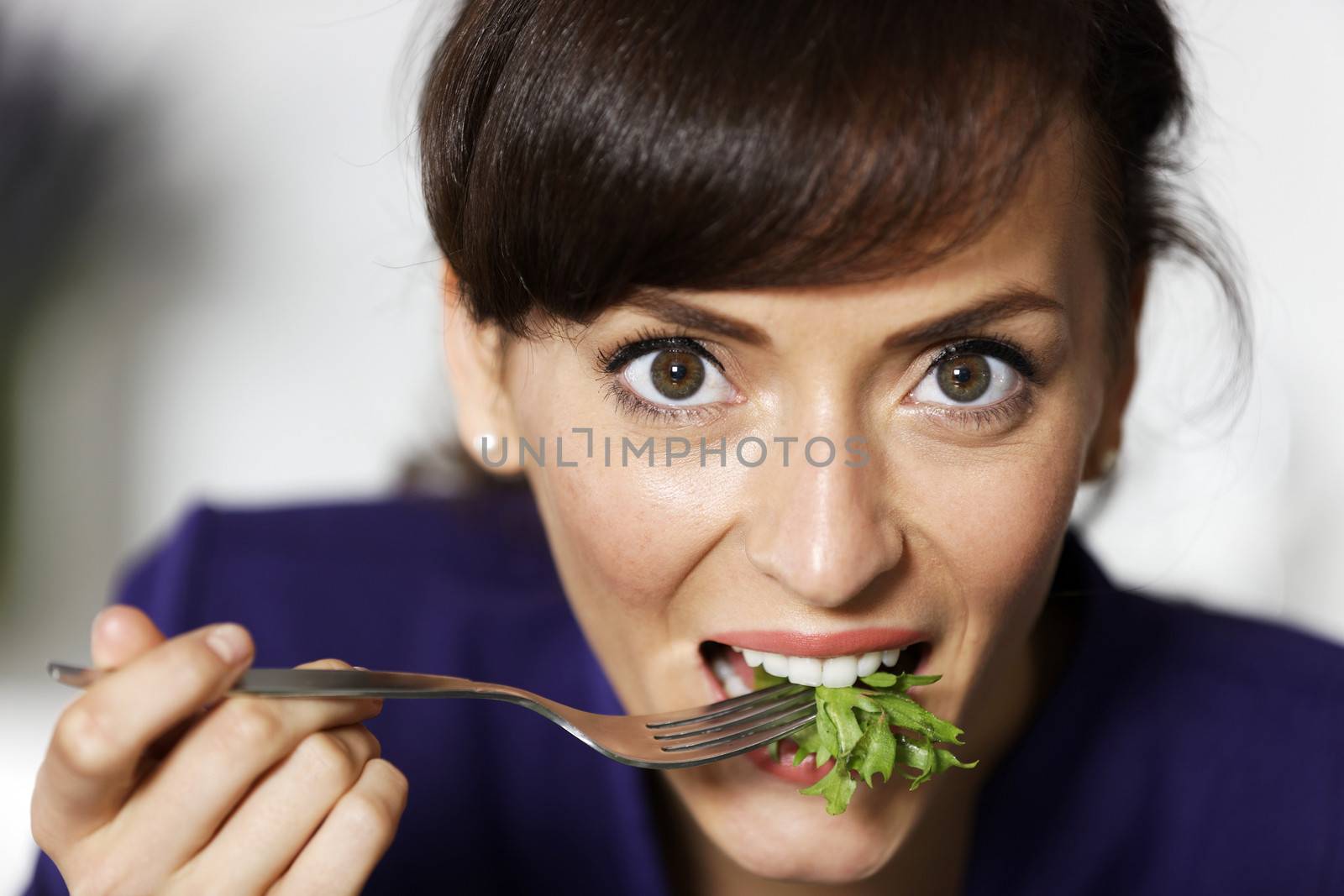 Attractive young woman enjoying a fresh salad.