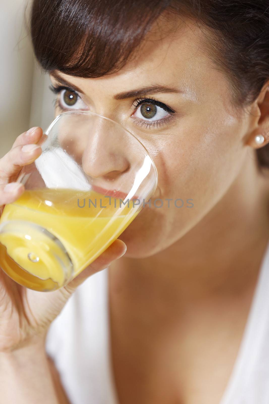 Woman drinking juice by studiofi