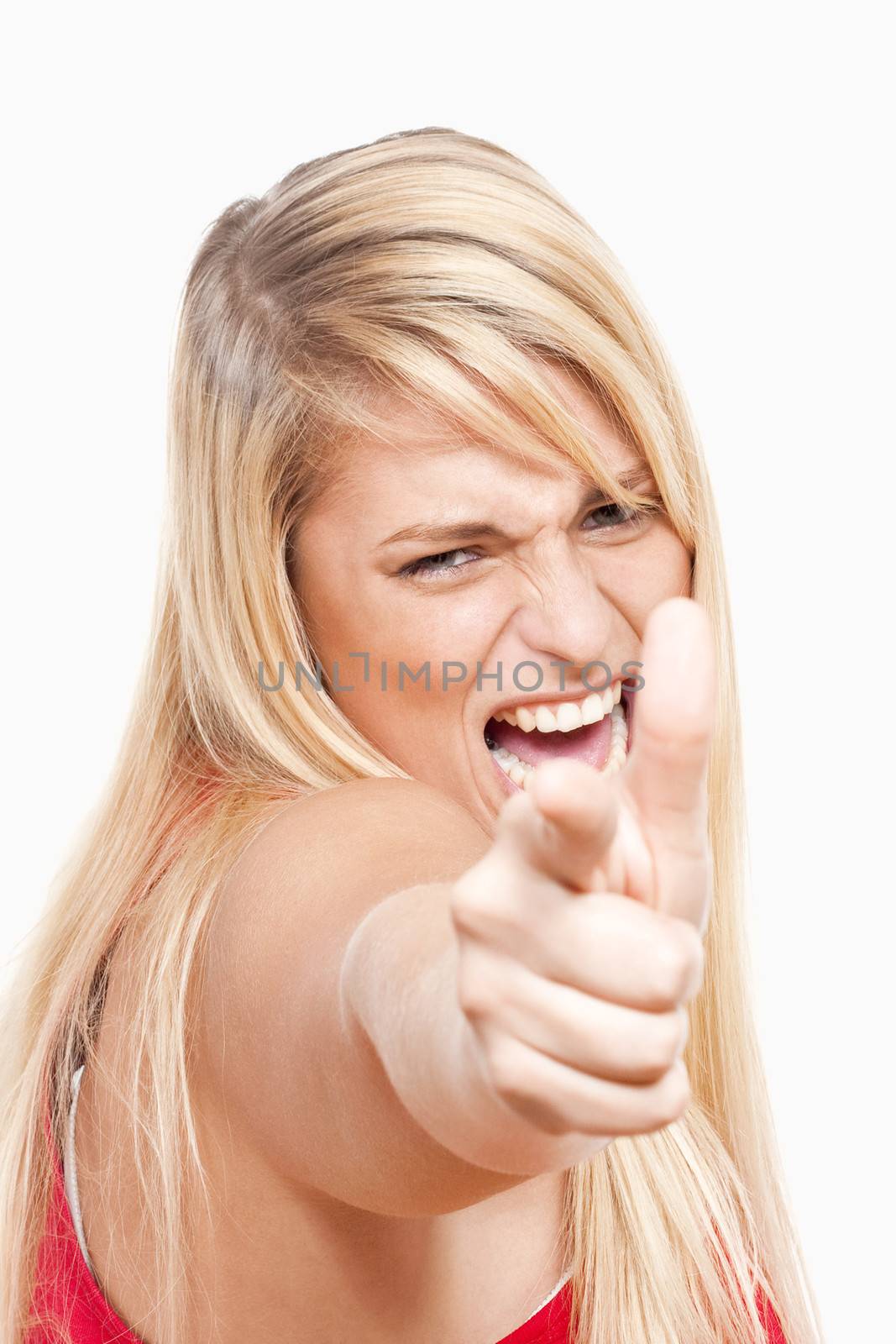 angry young woman pointing her finger at the camera - isolated on white