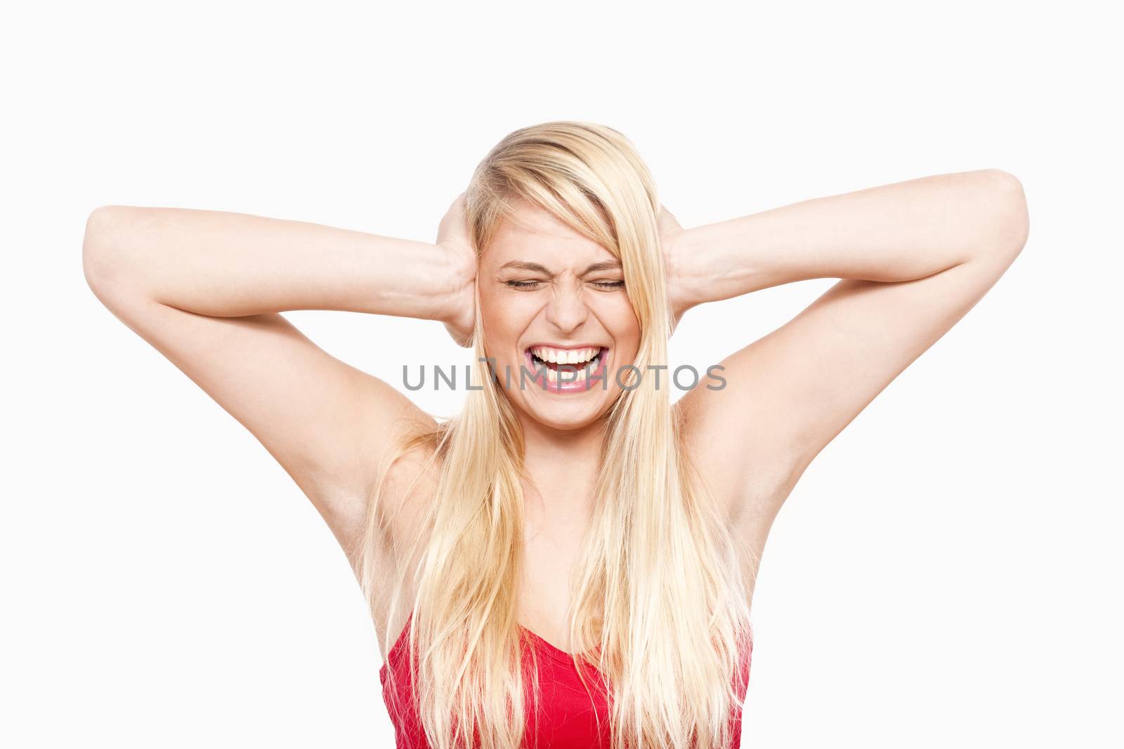young girl covering ears with her eyes closed, mouth open - isolated on white