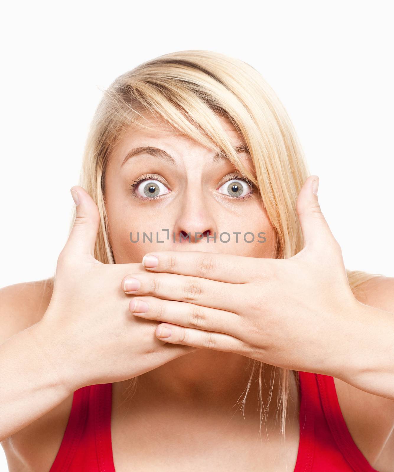 surprised young girl covering mouth with her hands looking