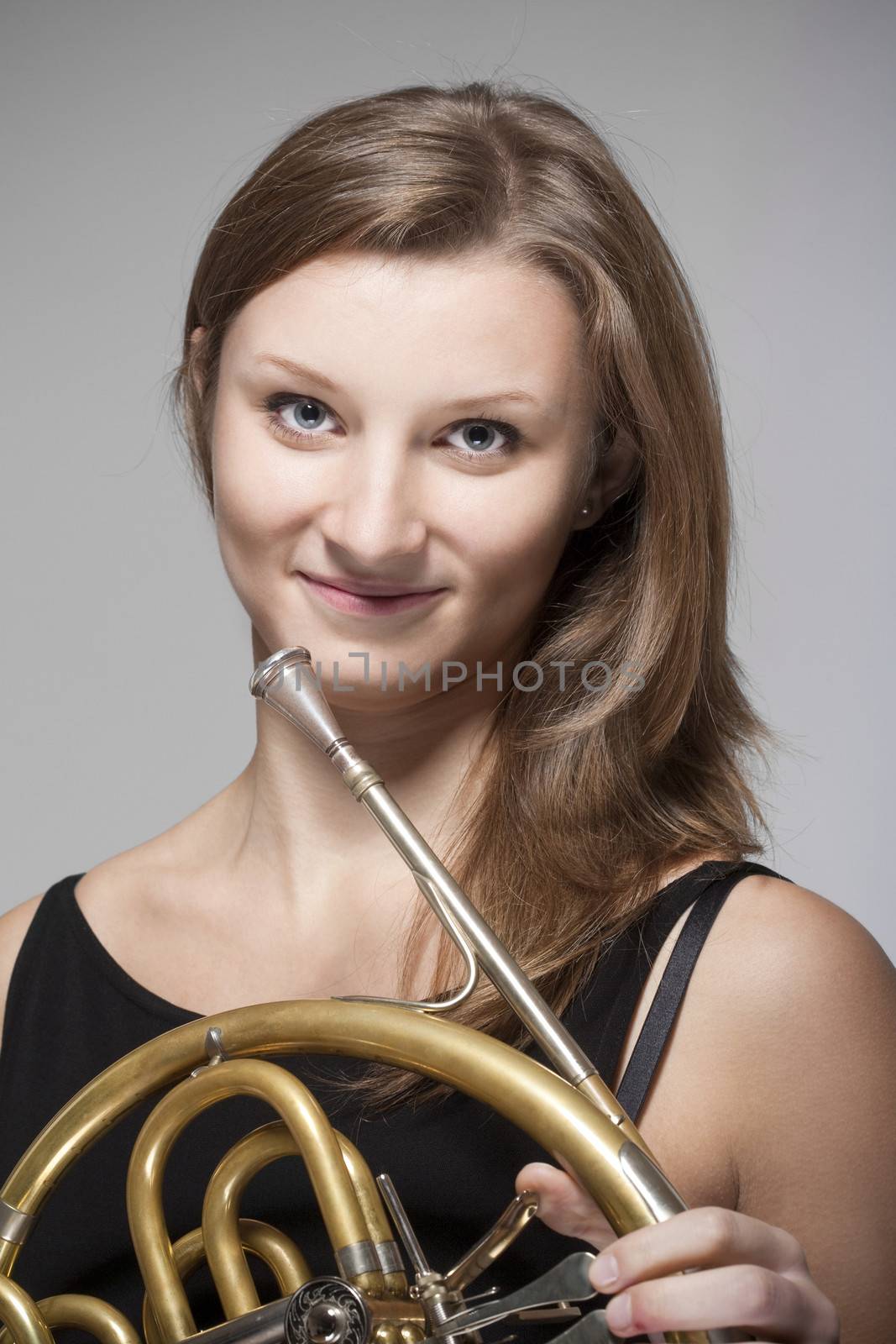 woman musician with french horn by courtyardpix