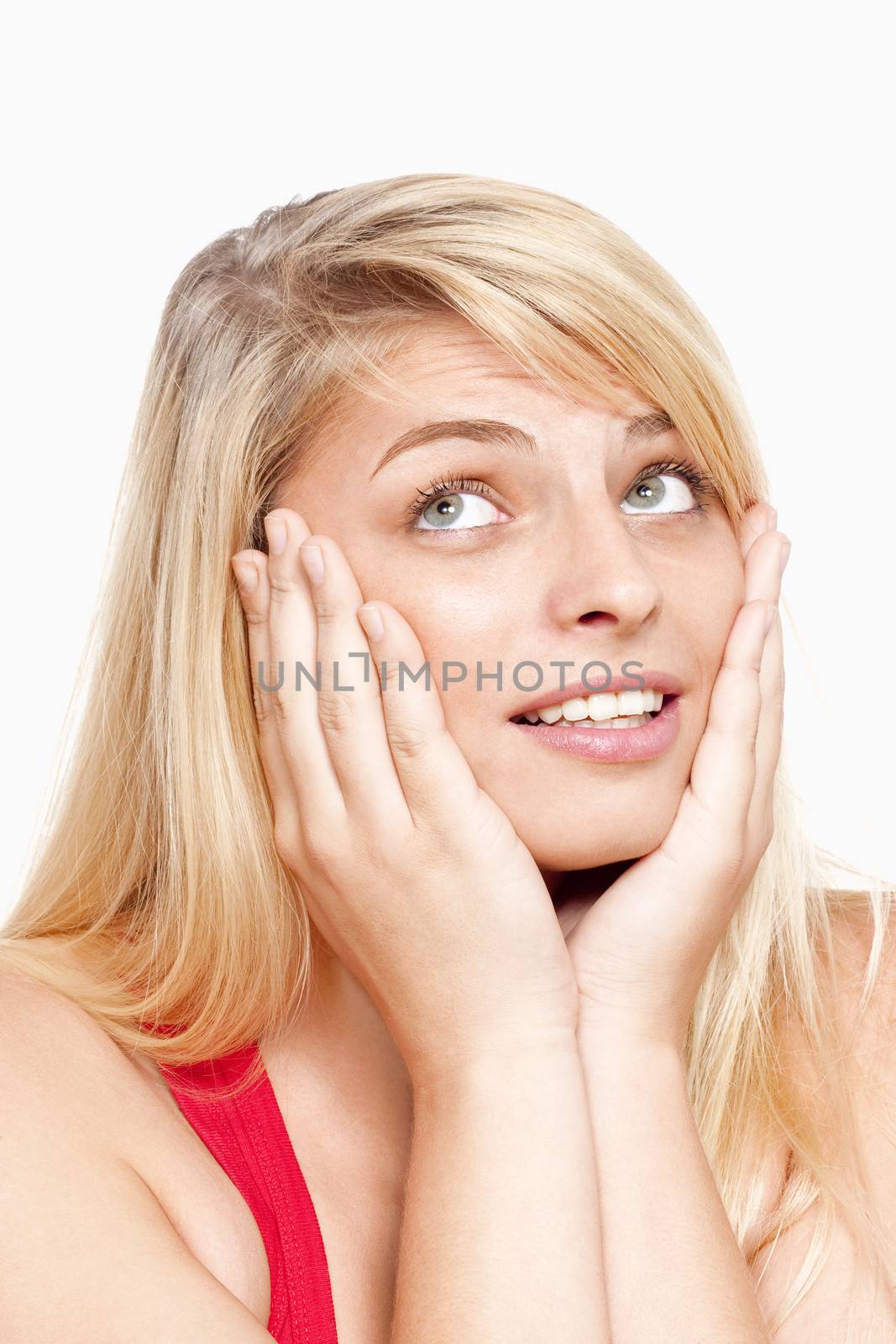 young woman with face in her hands thinking, looking - isolated on white