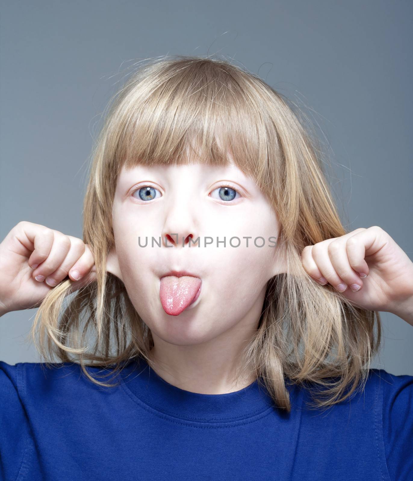 boy sticking out tongue by courtyardpix