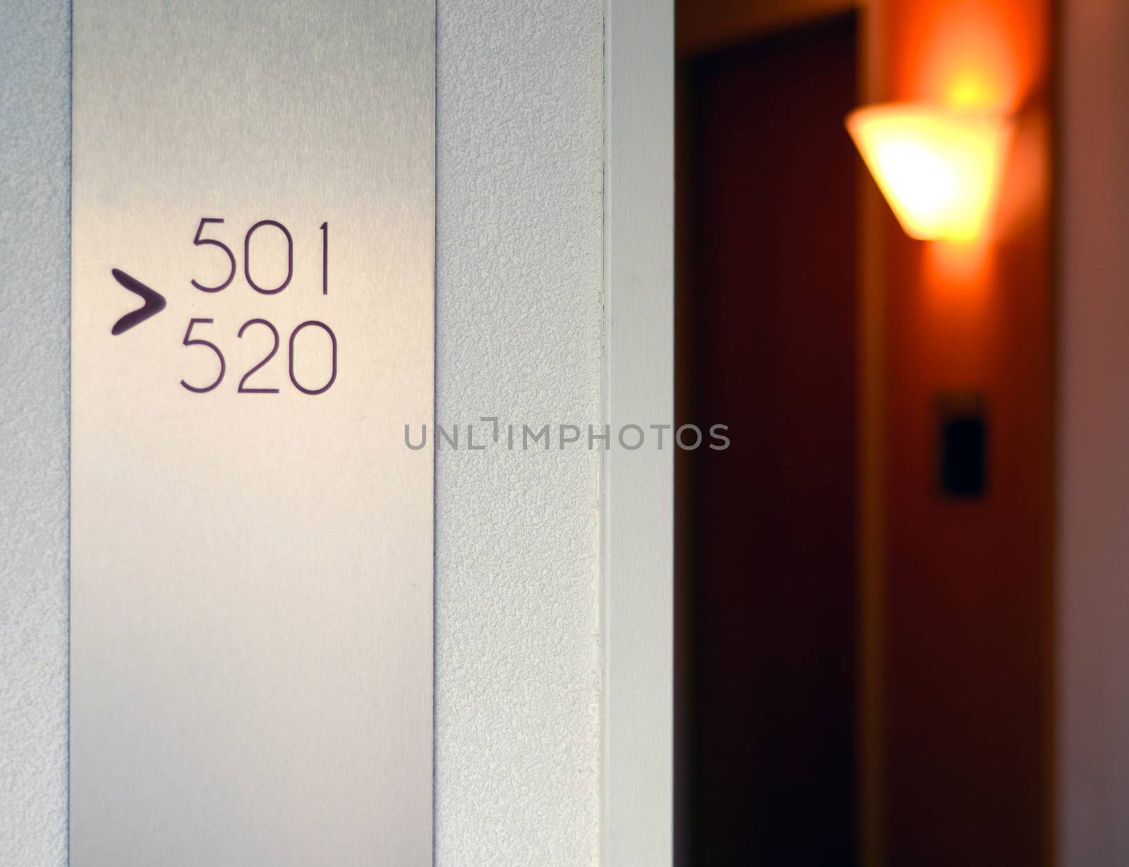 Travel Image Of A Hotel Corridor With Light And Sign