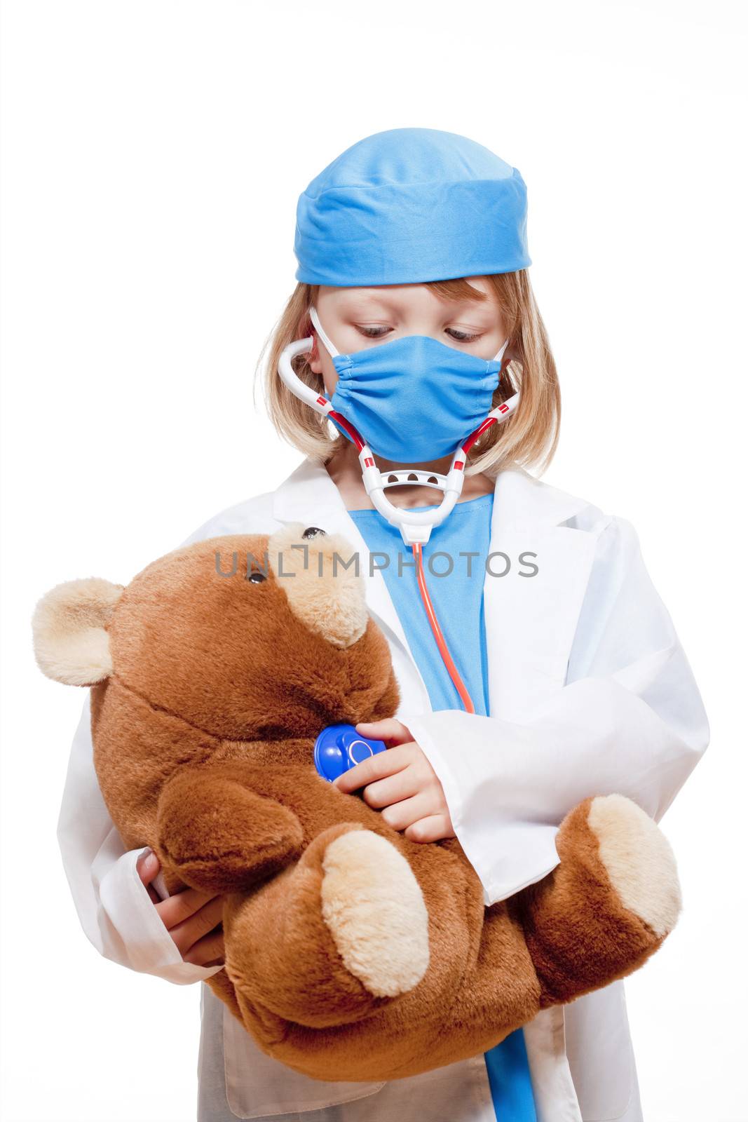 boy with long blond hair playing a doctor