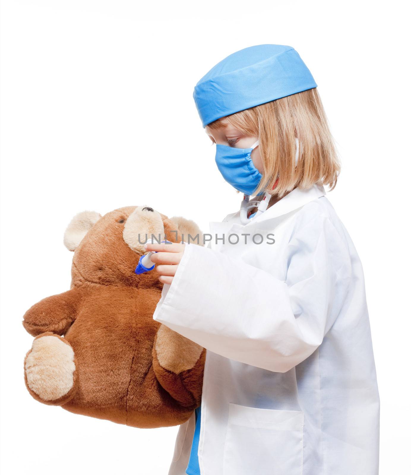 boy with long blond hair playing a doctor