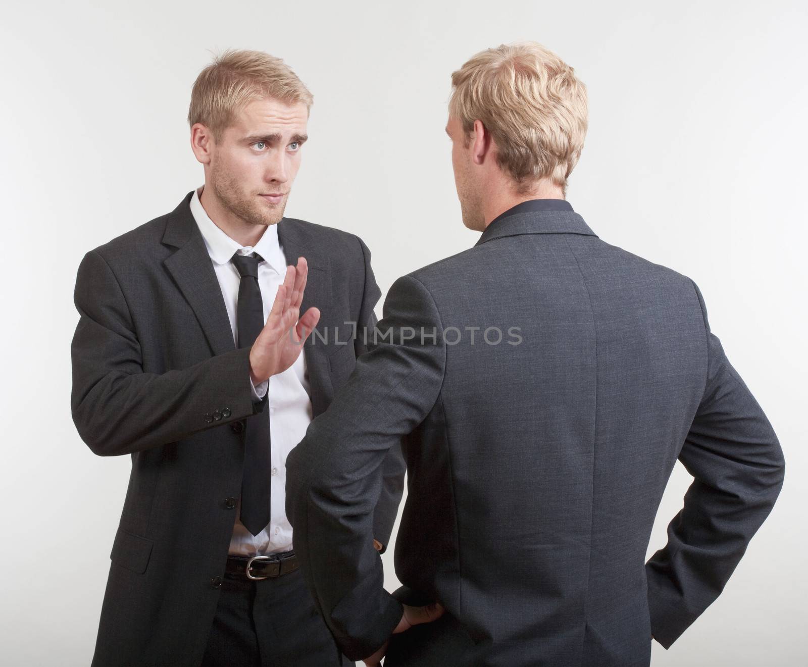 two you businessmen standing, discussing, arguing