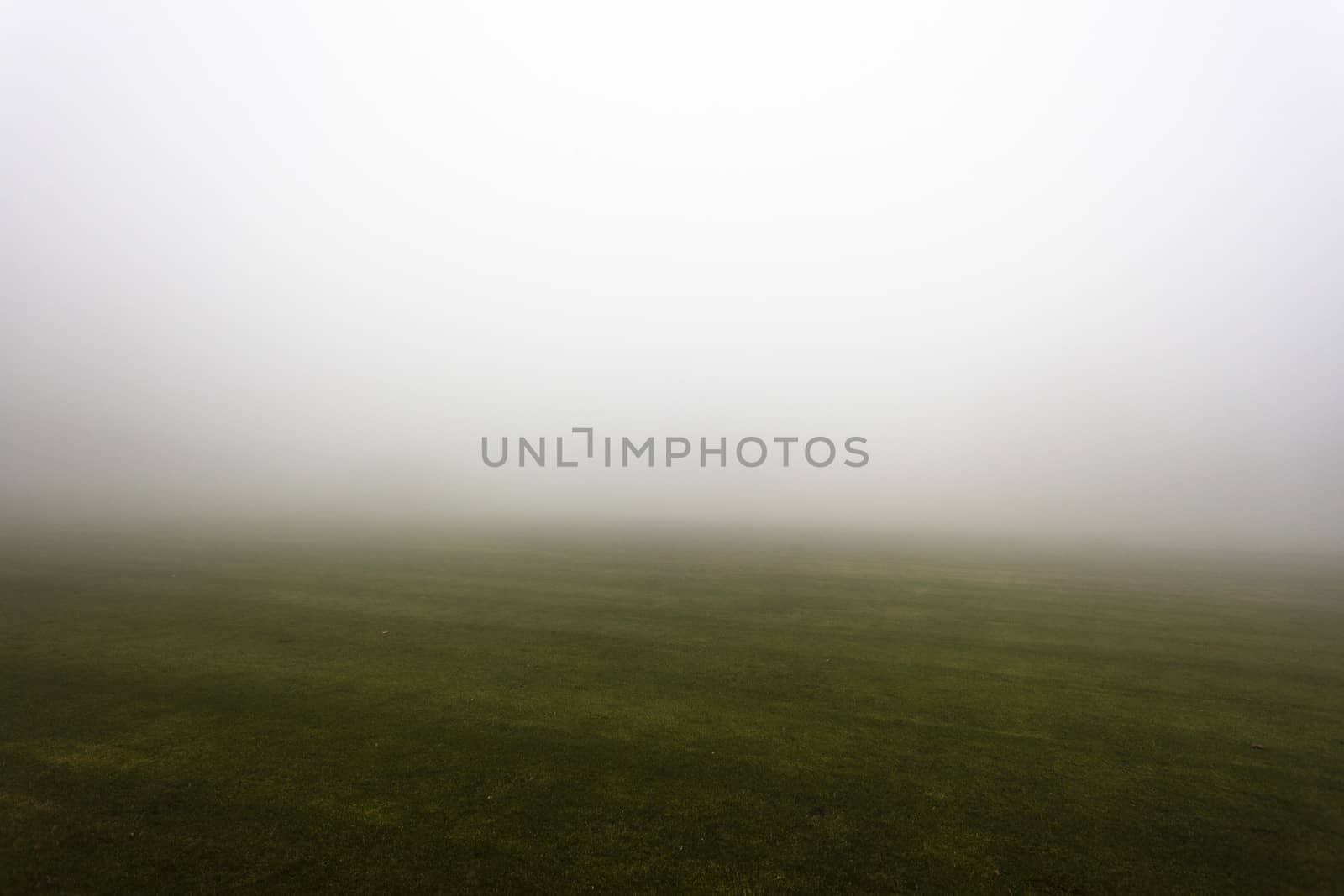 Sports field covered in mist with season weather