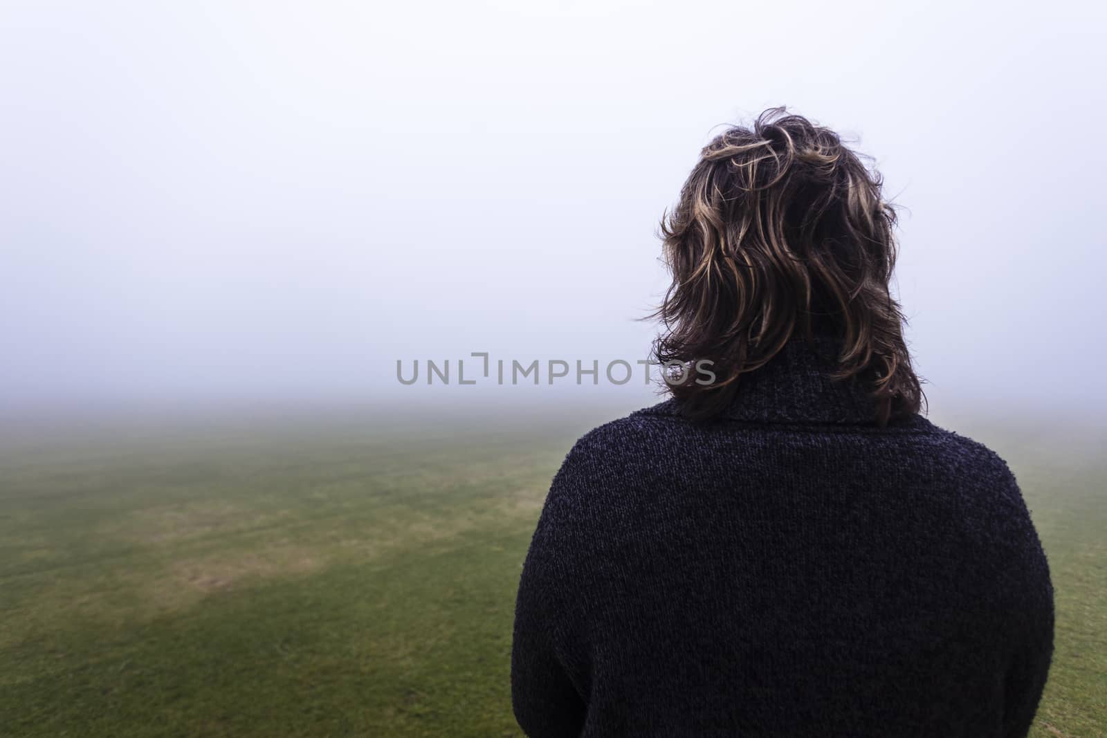 Woman Unidentified looks into the season mist over the field pending future days.