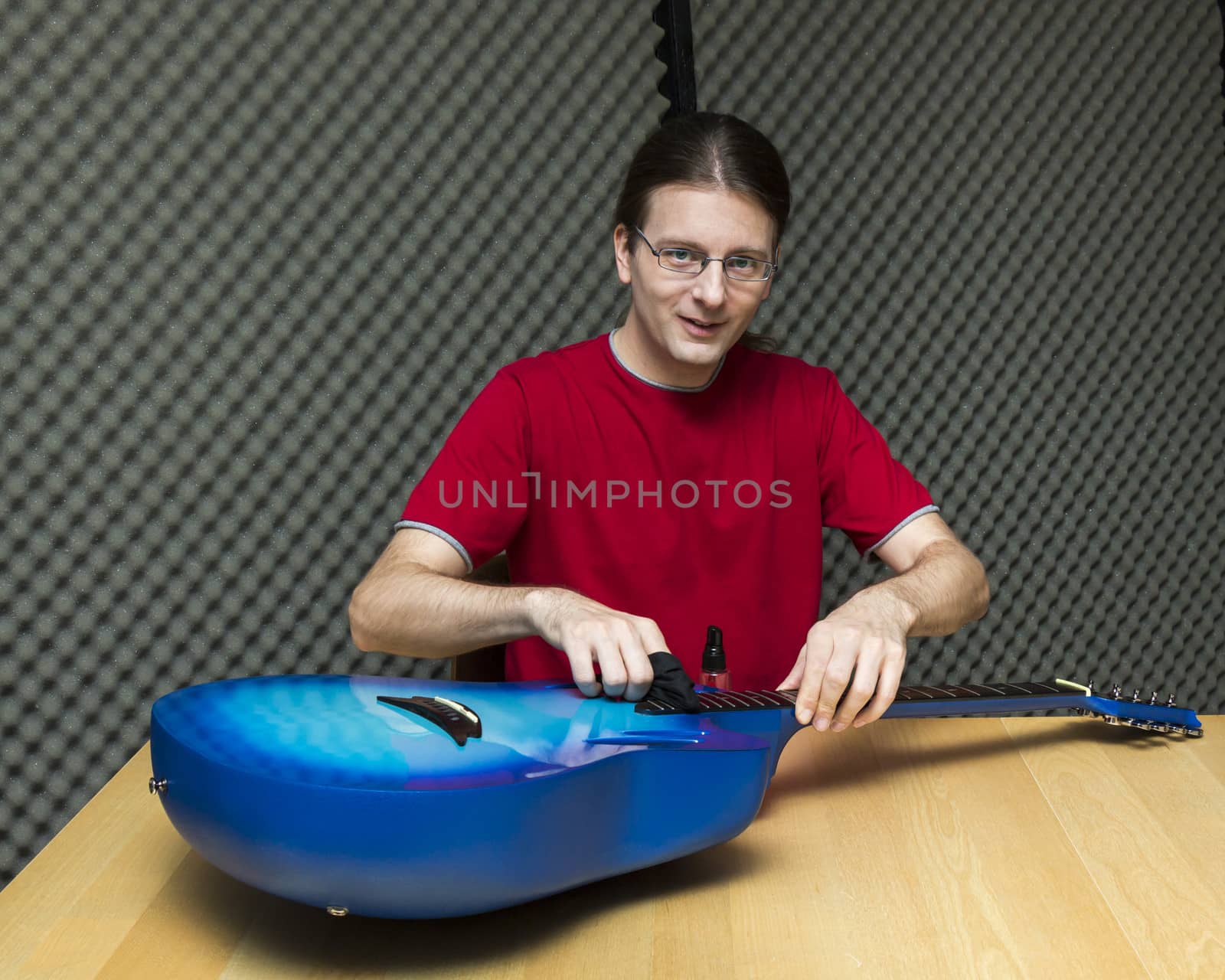 Guitar technician cleaning the guitar ( Series with the same model available)