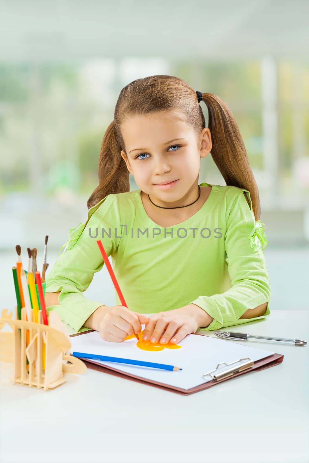 schoolgirl do homework at the table