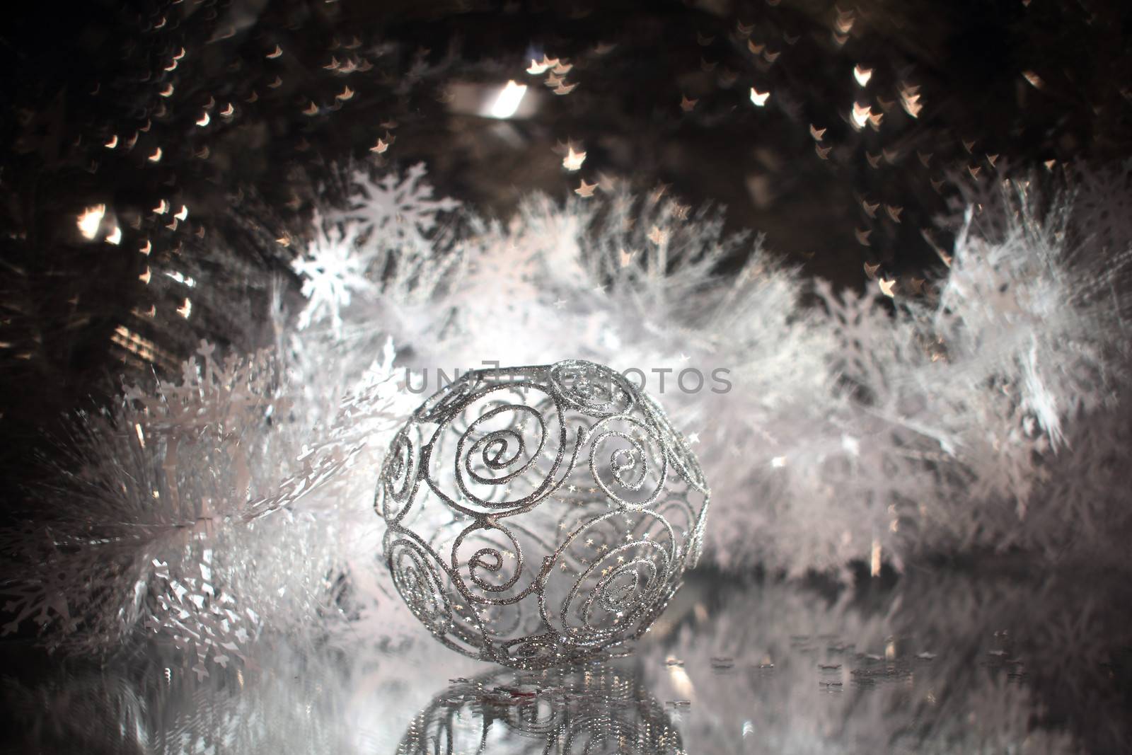 Silver christmas ball with shiny decorationand stars