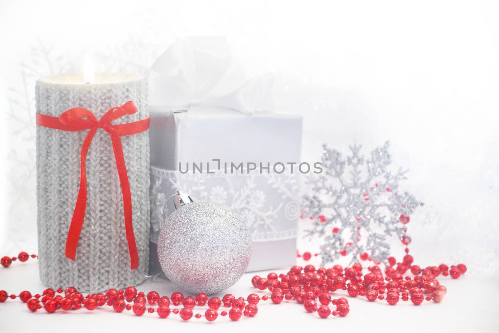 Christmas card with burning candle and decoration on white