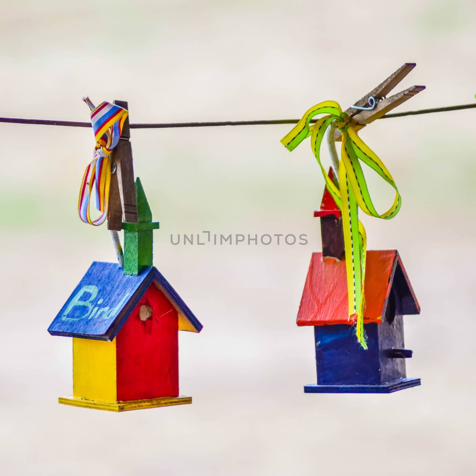 little colorful bird houses on clothes line