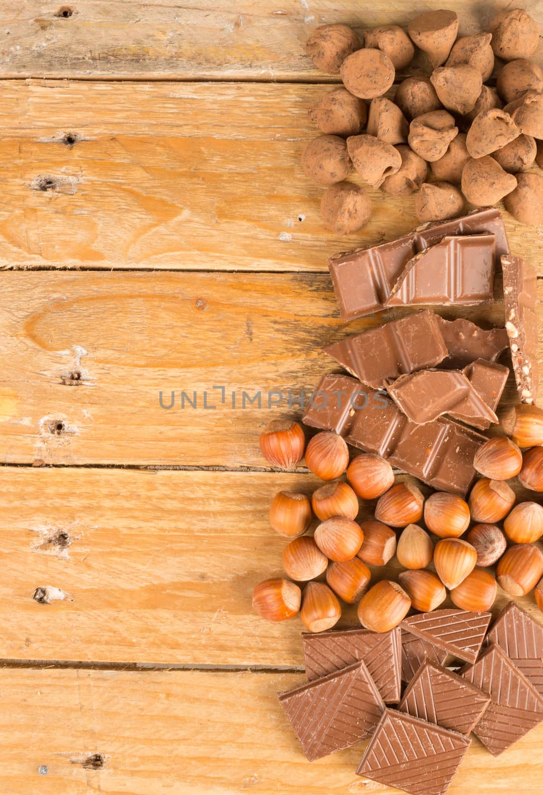 Chocolate candy and nuts displayed on an old wooden table