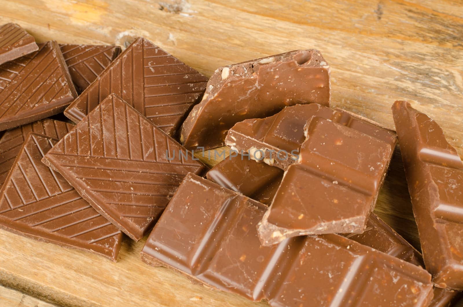 Pieces of  a chocolate bar on a wooden table