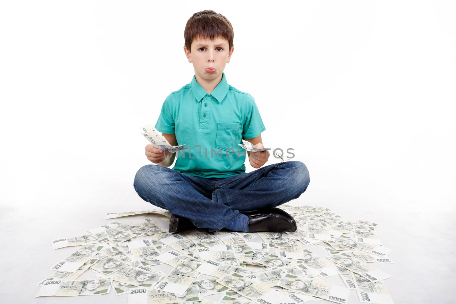 boy sitting on money, money concept, how to be successful, isolated on white background