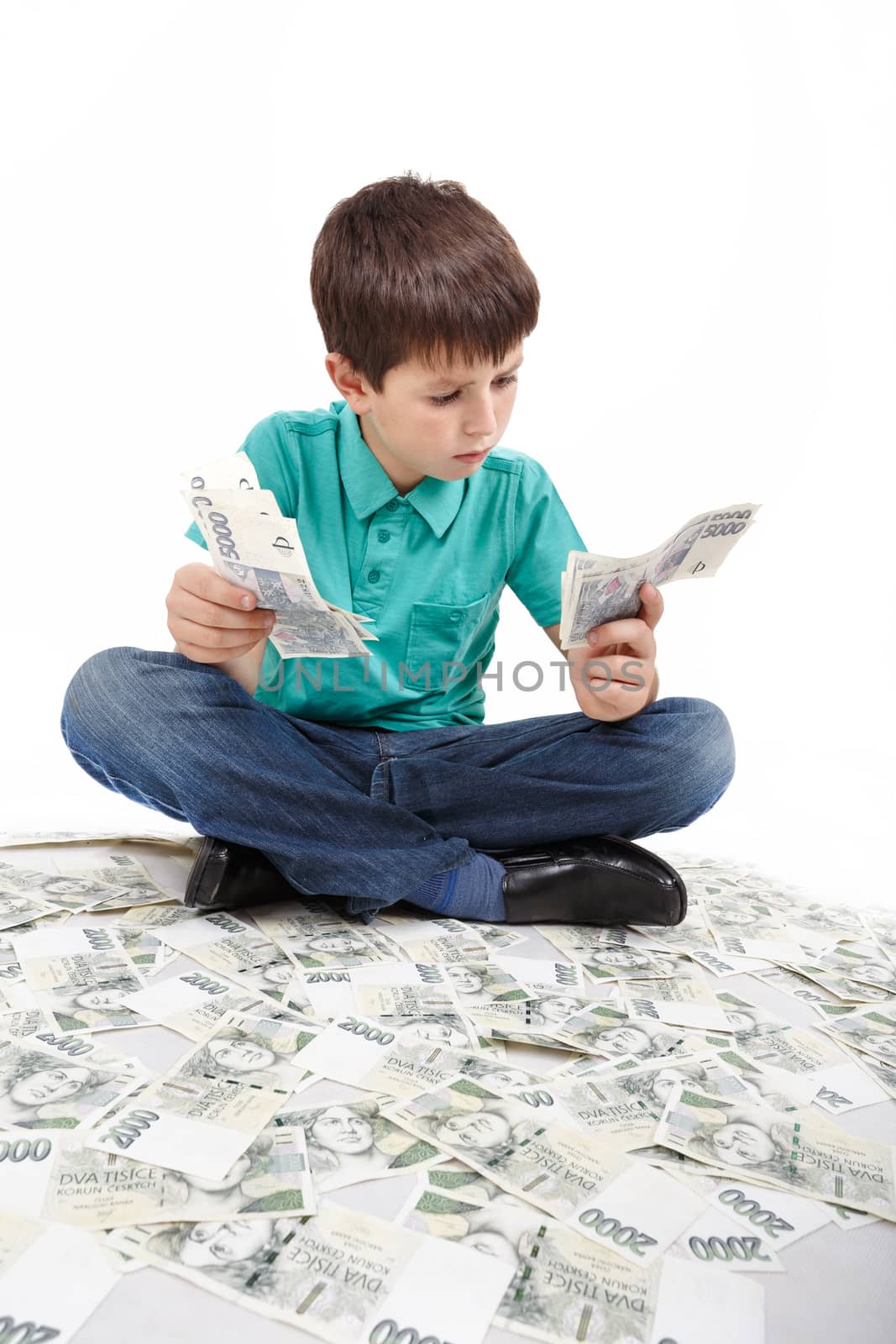 boy sitting on money, money concept, how to be successful, isolated on white background