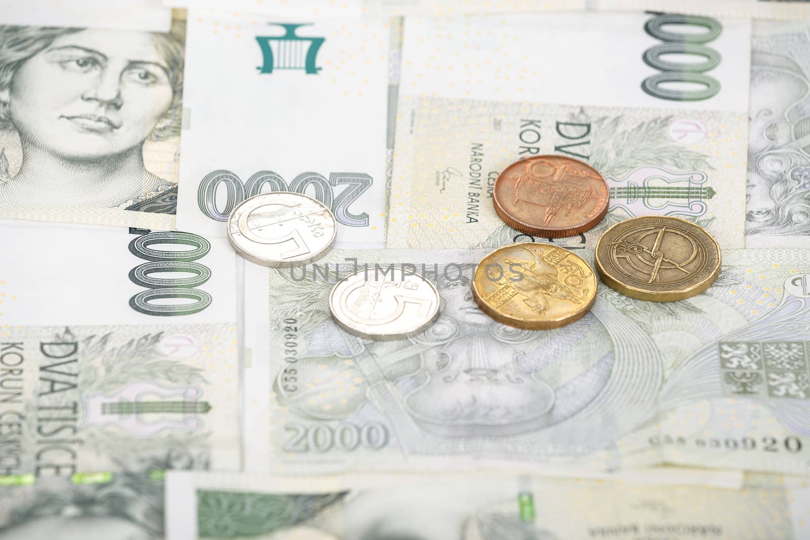 czech banknotes nominal value two thousand crowns and coins as background