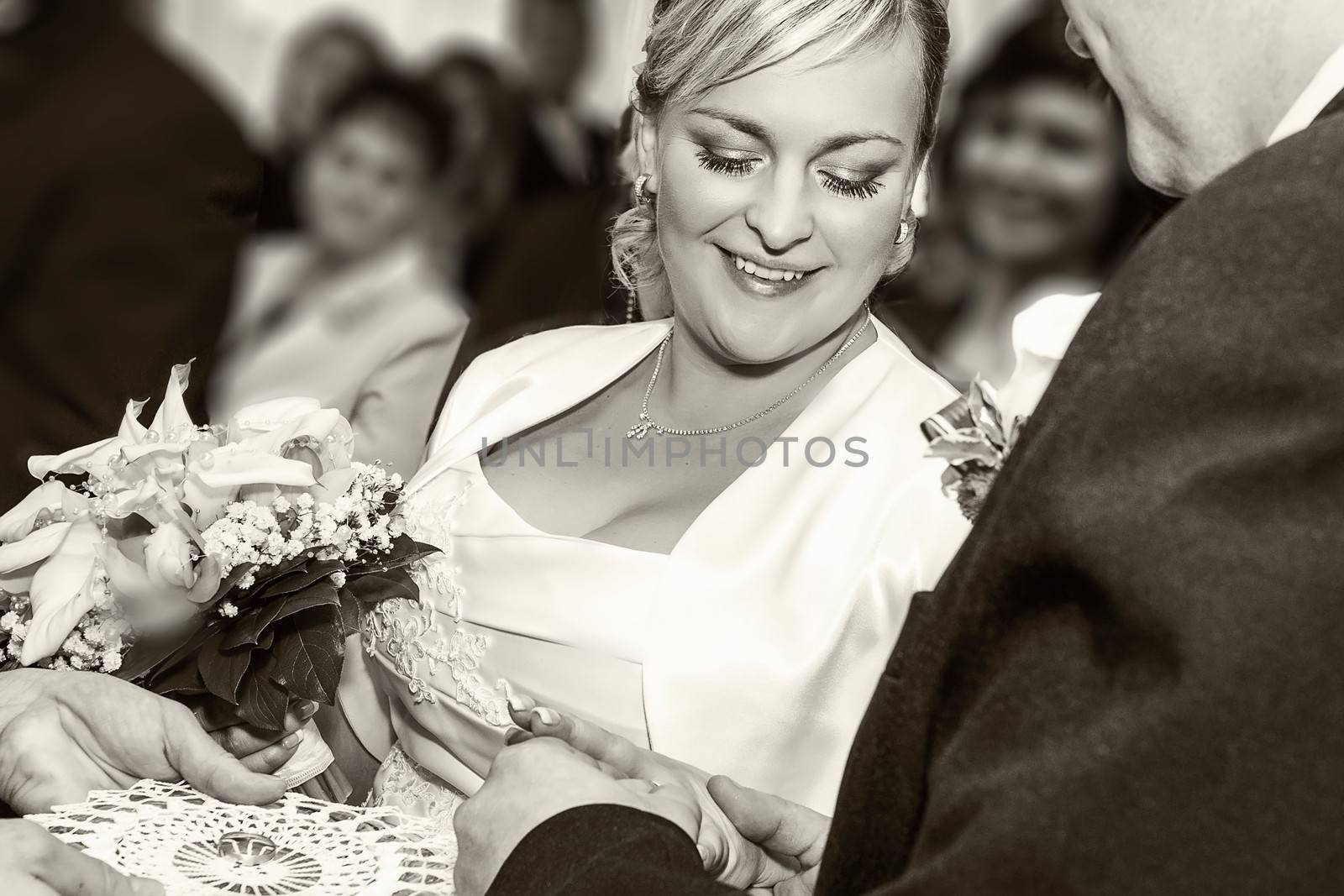 Groom Happy putting ring on smiling pretty woman bride's finger, Black and white stock photo