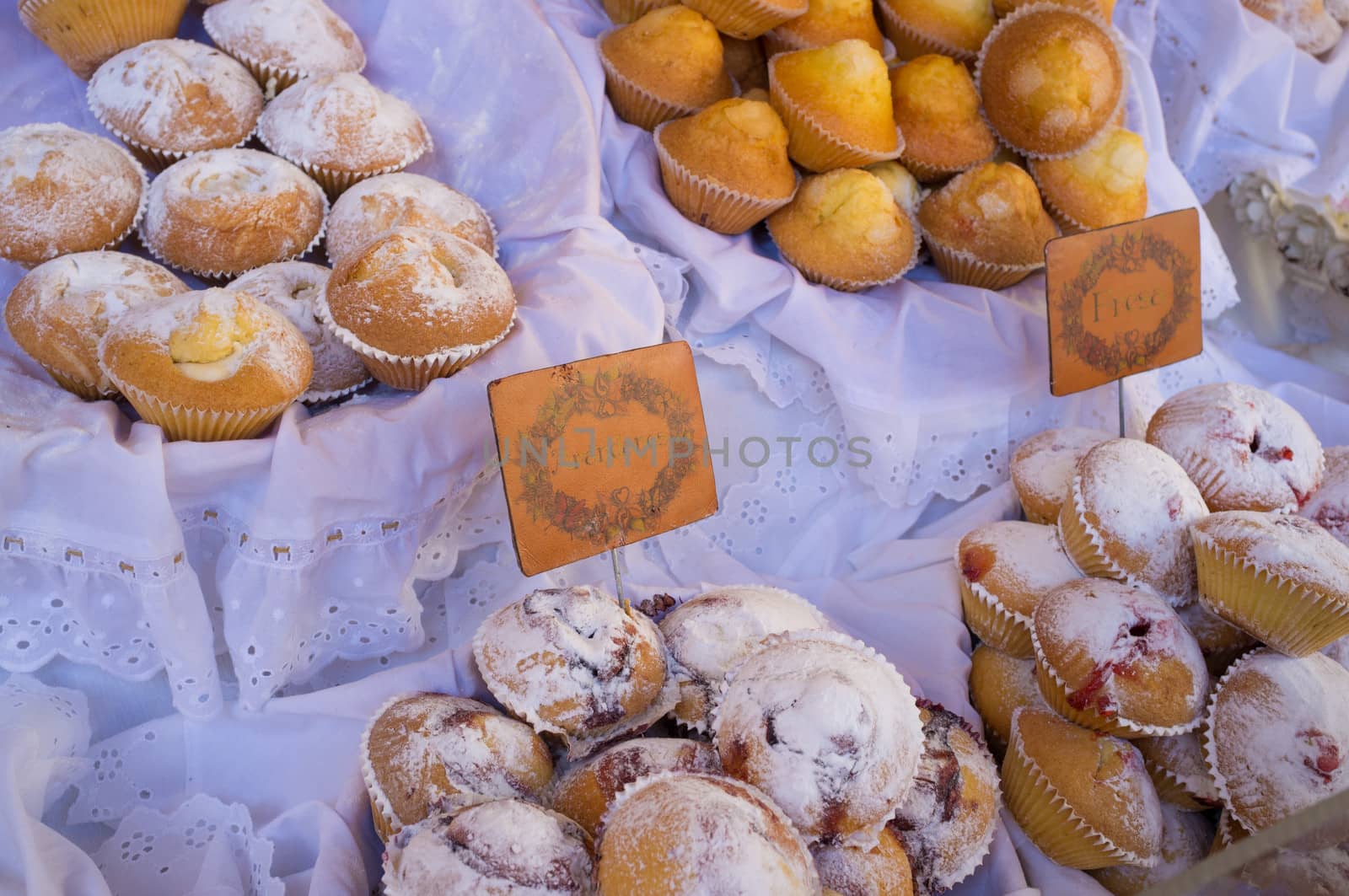 Assorted muffins on display on a traditional street market stall