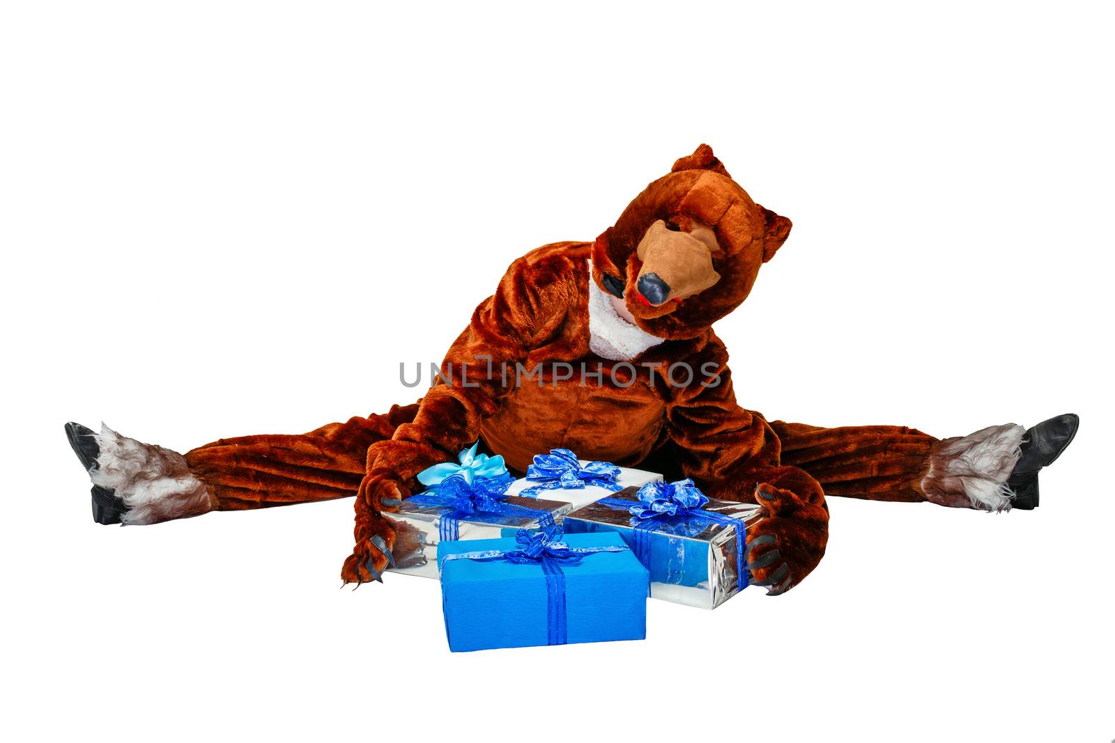 Girl in a bear costume holding Christmas gifts isolated on white background