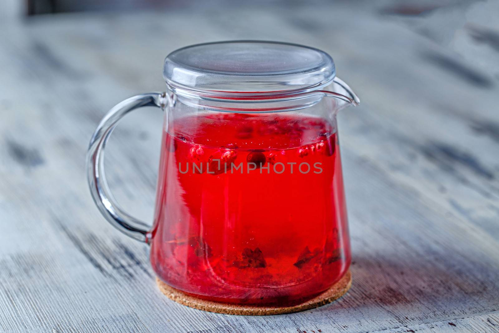 Glass tea kettle on the wooden table closeup shot