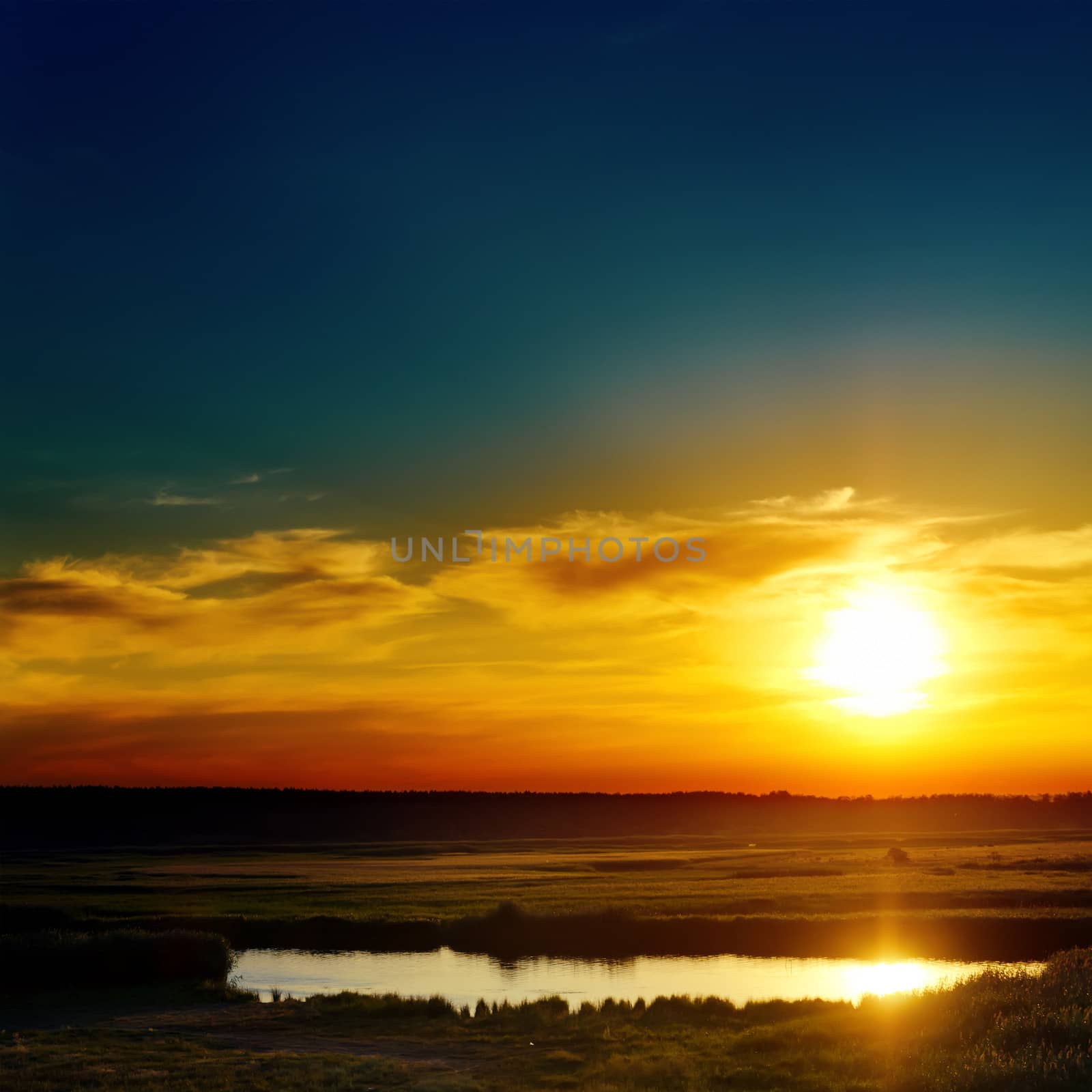 blue and orange sunset over lake