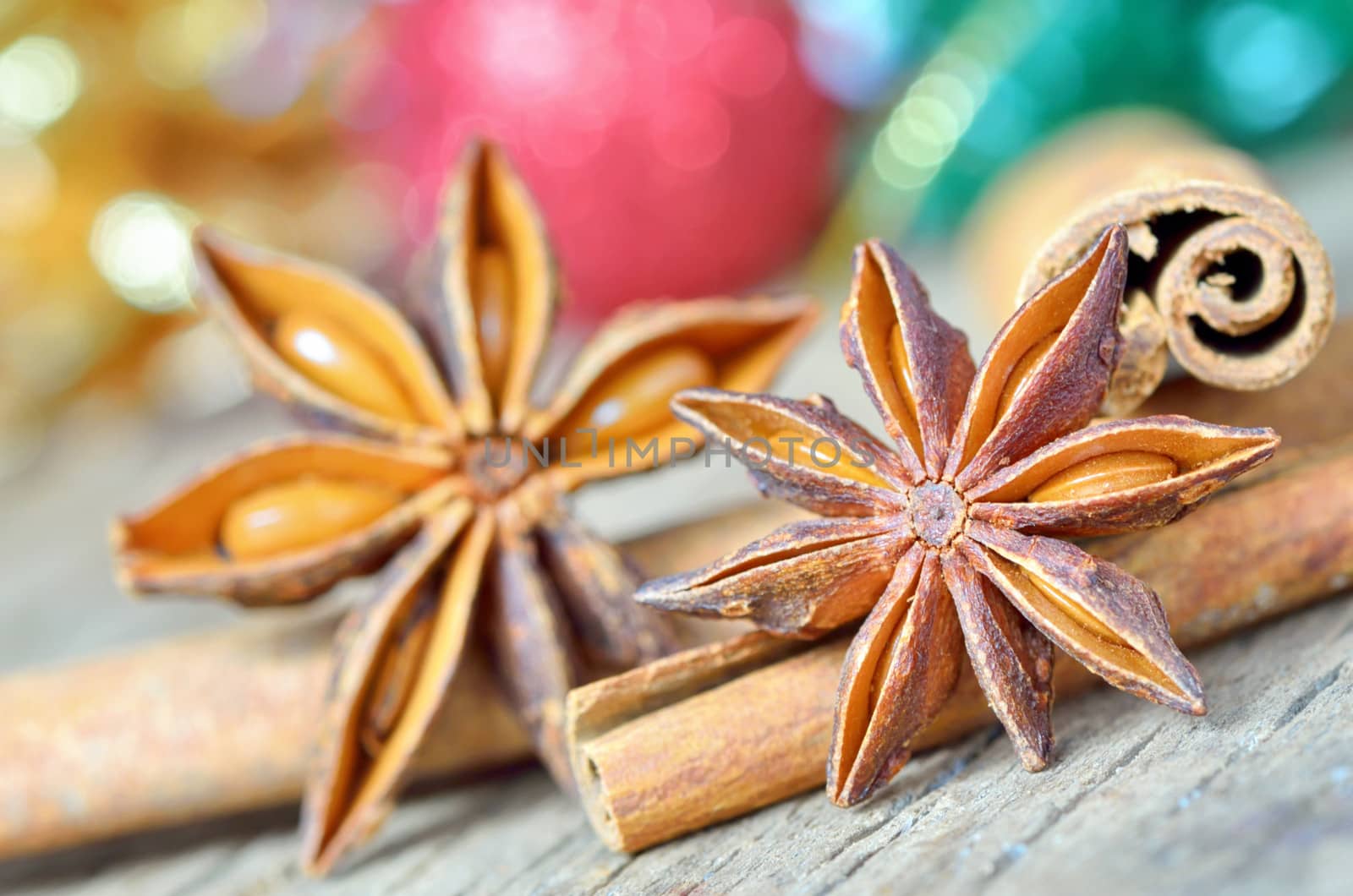 extremely closeup view of anise star and cinnamon sticks, on wooden table
