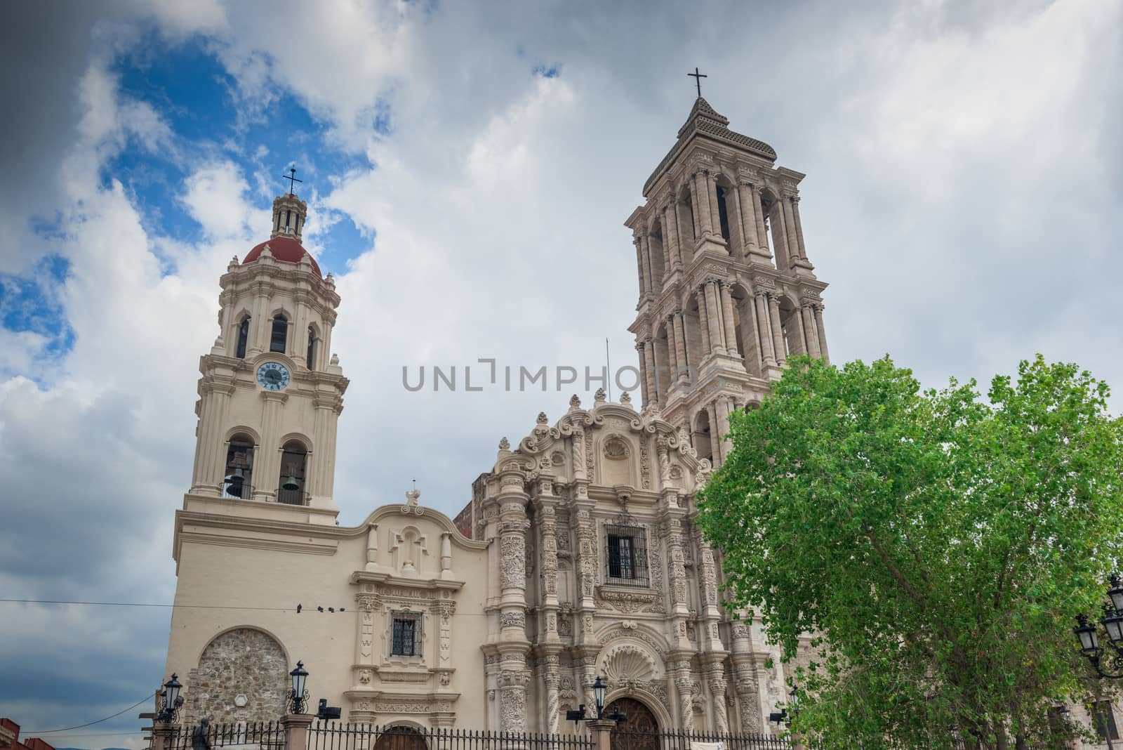This is the very lovely Catedral de Santiago.The front facade is very exuberant and baroque. It has beautifully carved heavy wooden doors in the front. Inside the church has a single aisle and is mostly neo-classical with a central dome and real transepts. In the transepts, however, the neo-classical gives way to more baroque with gilded altars.