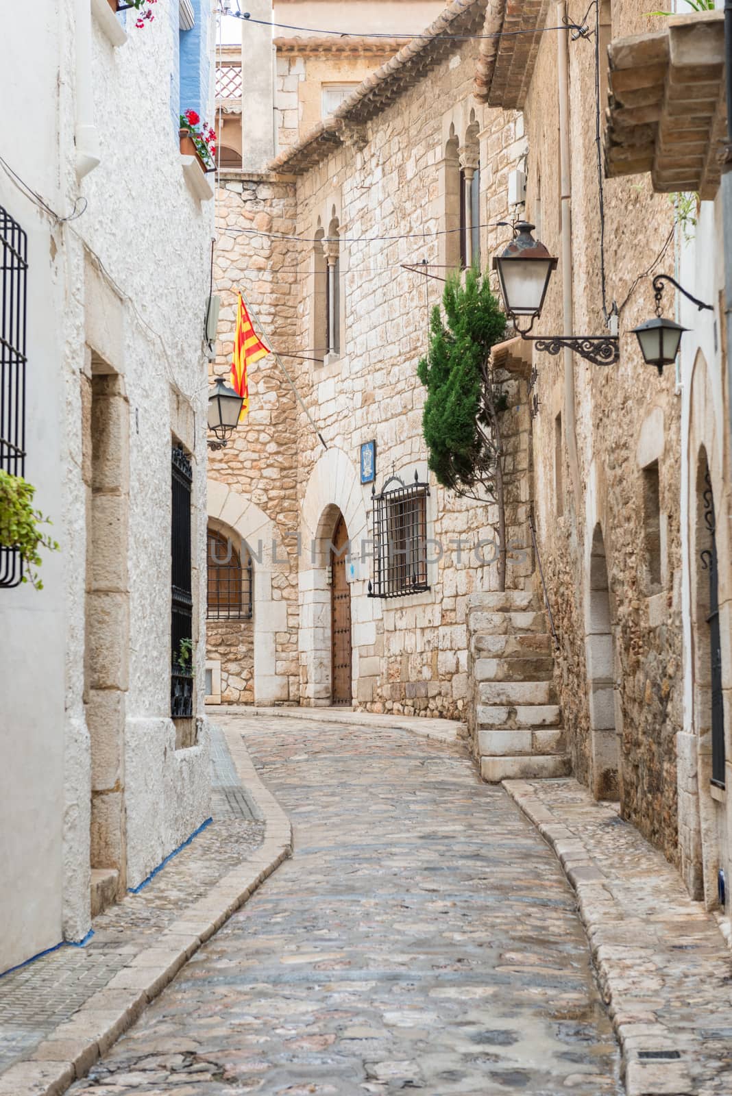Medieval street in Sitges old town, Spain by Marcus
