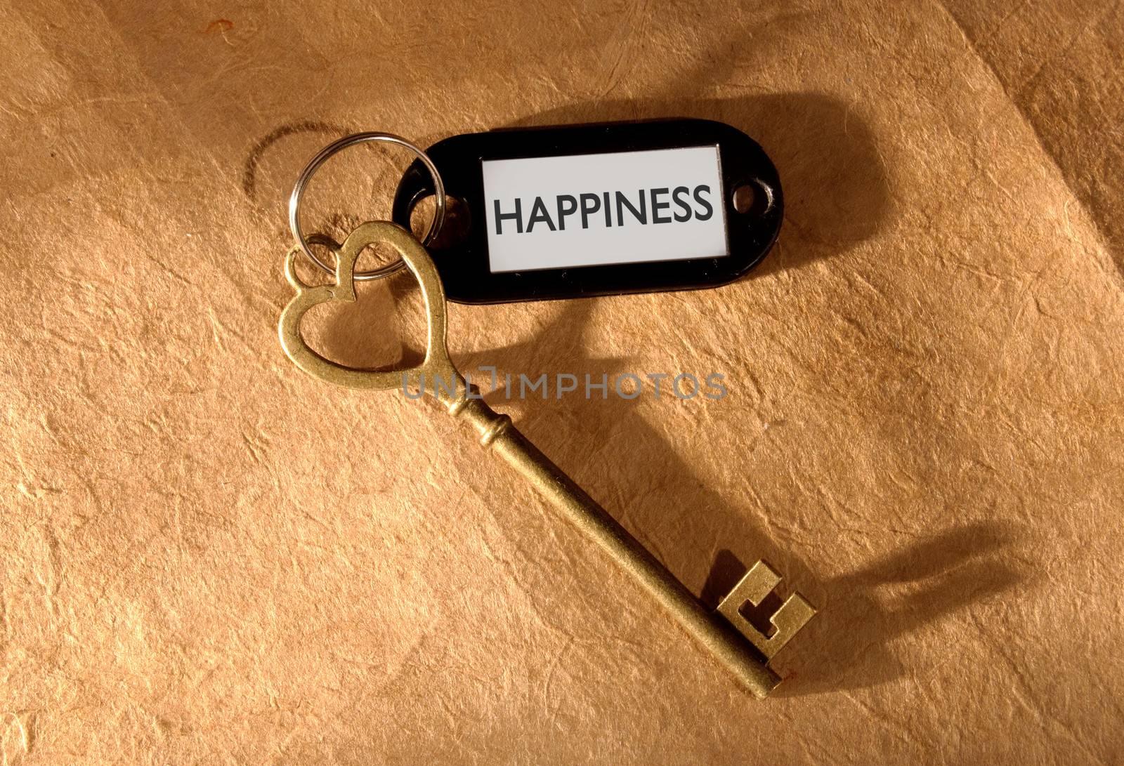 Happiness label attached to a heart shaped key