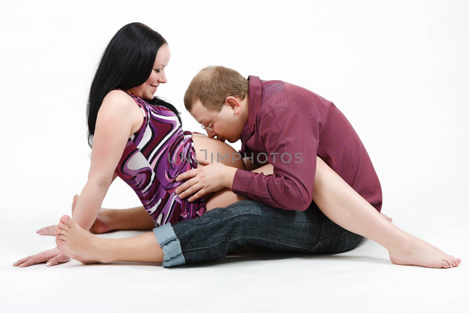 Young happy couple. Husband and pregnant wife. studio photography