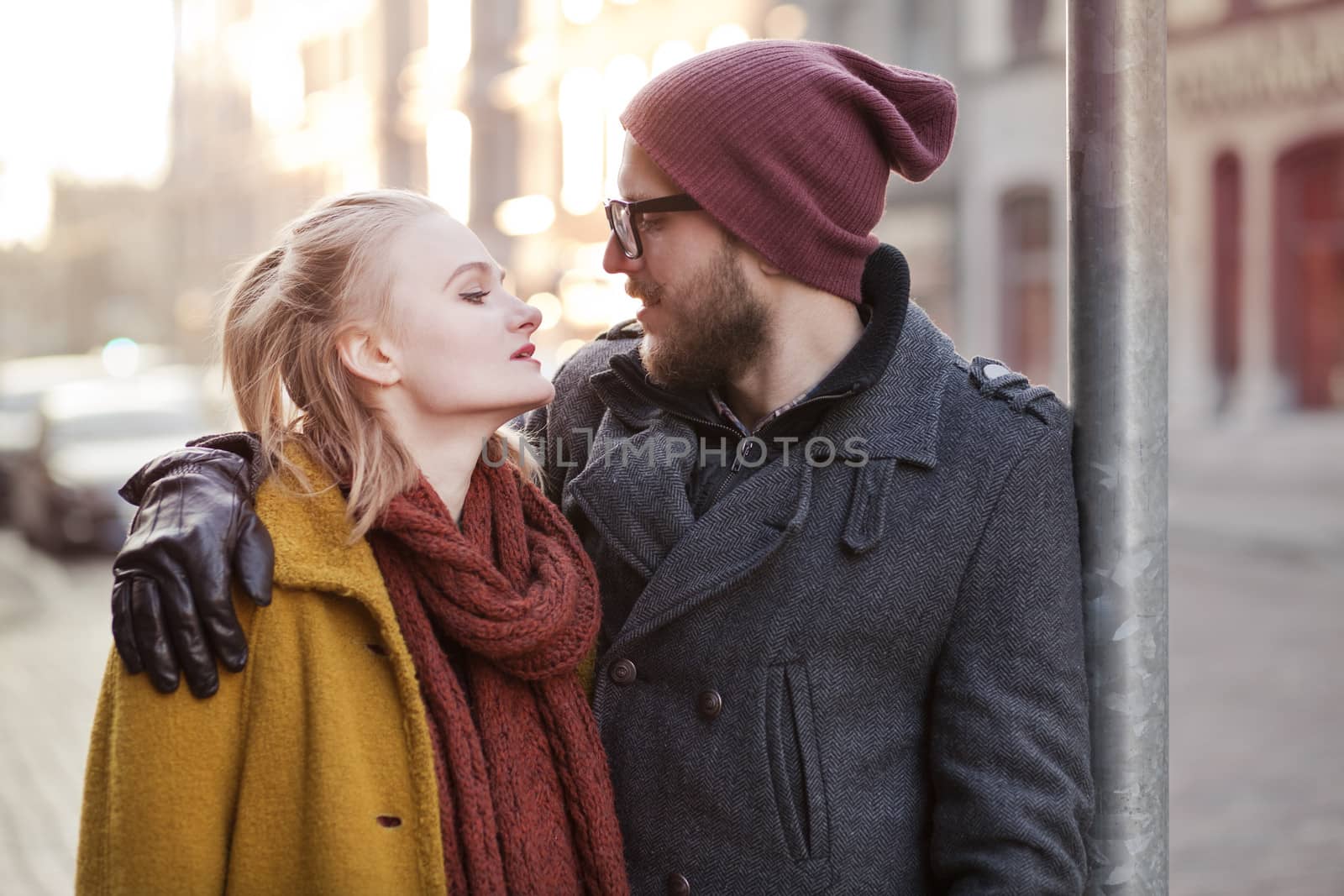 Young smiling happy hipster couple hugging in winter
