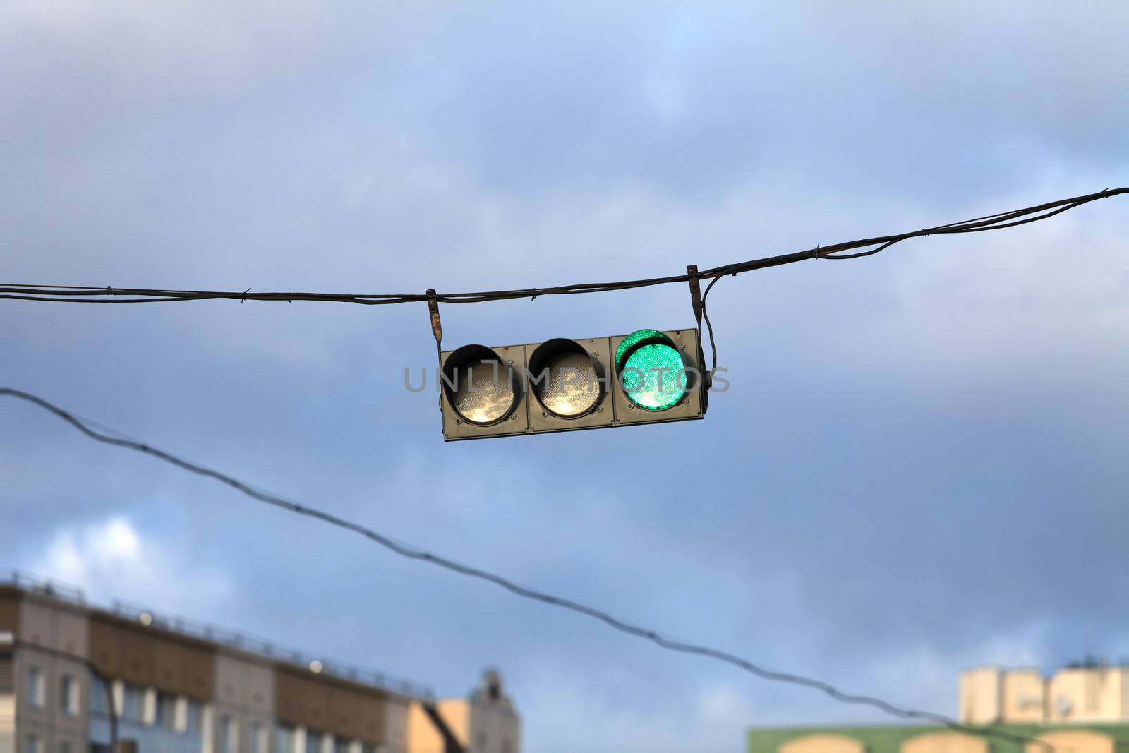 Traffic light on the background of the storm sky