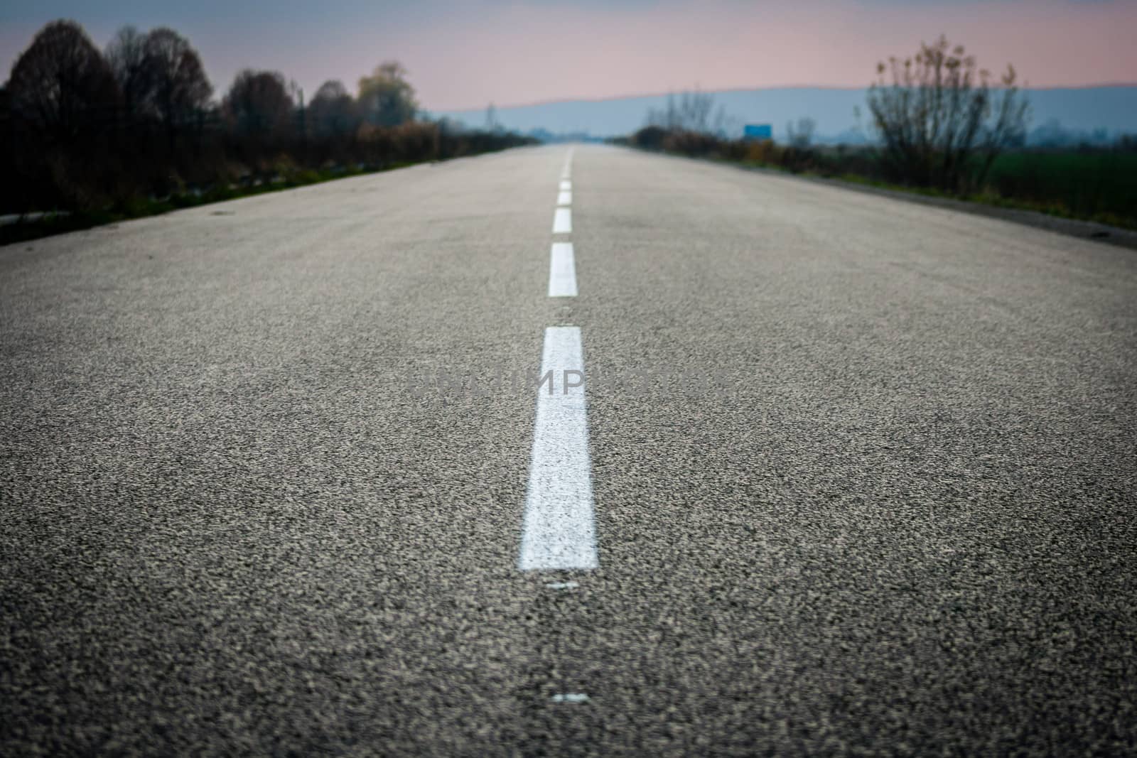 Deserted road with white stripes