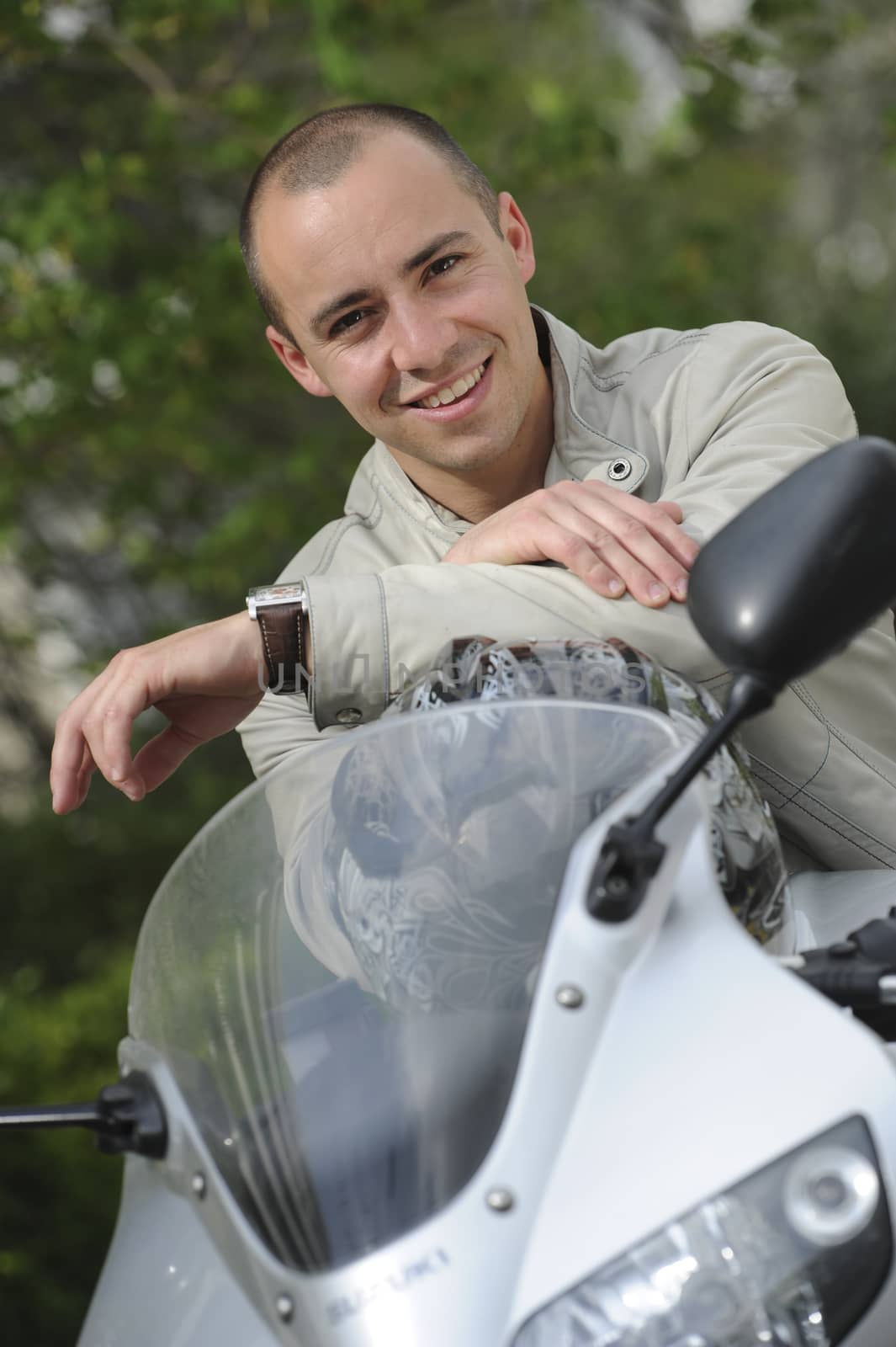 Young man with motorcycle by FreeProd