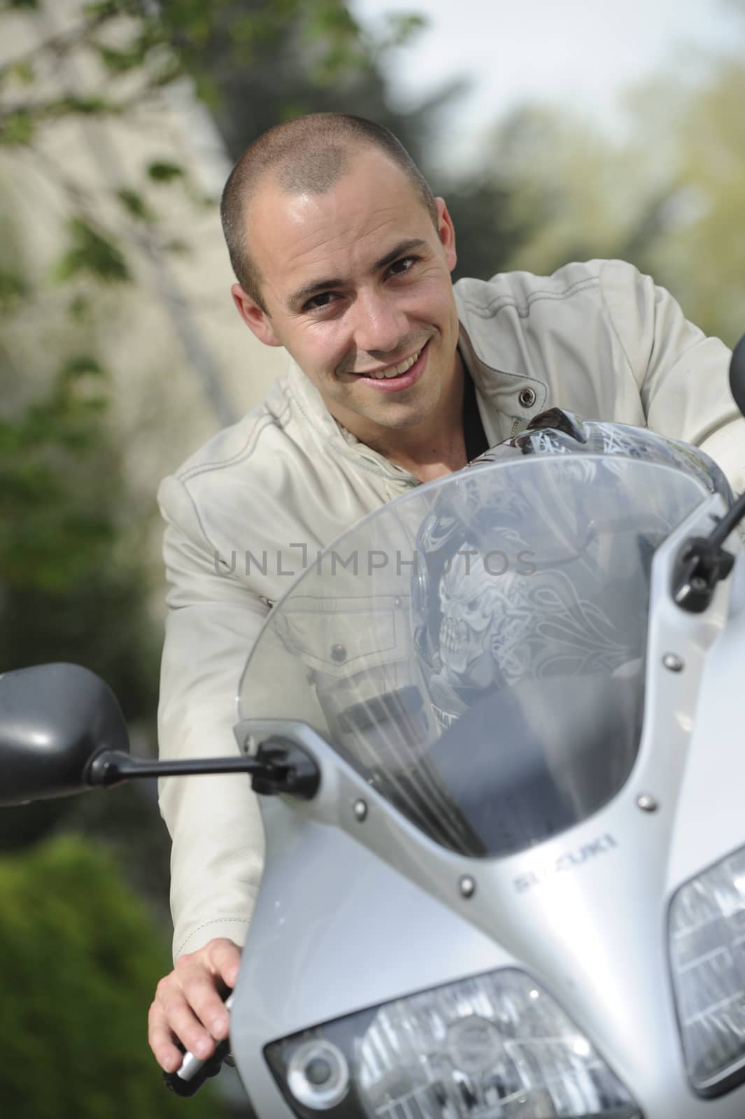 Young man with motorcycle by FreeProd