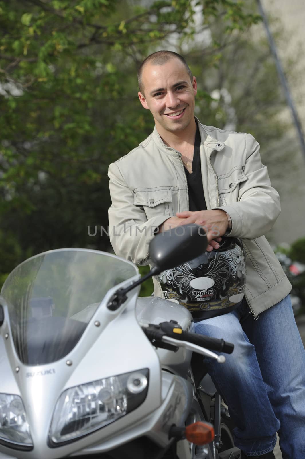 Young man with motorcycle by FreeProd