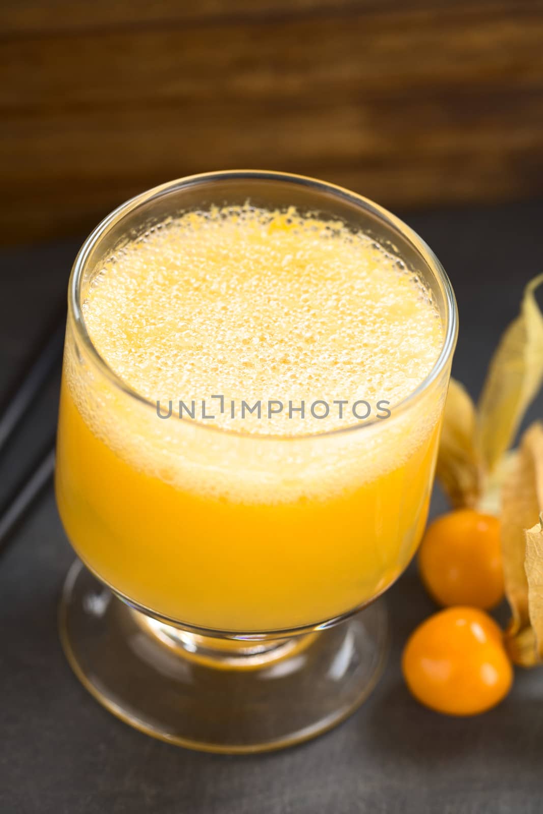 Peruvian cocktail called Aguaymanto Sour (Physalis Sour) prepared from physalis juice, pisco (Peruvian grape hard liquor), syrup and egg white (Selective Focus, Focus in the middle of the froth) 