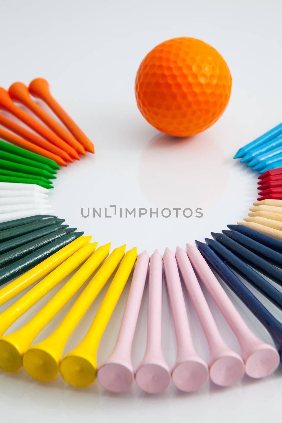 The different colorful wooden golf tees on the white background