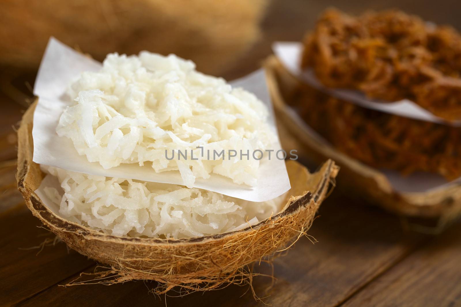 Peruvian cocadas, a traditional coconut dessert sold usually on the streets, made of grated coconut and white or brown sugar, which gives the different coloring of the sweet (Selective Focus, Focus on the front of the cocadas)