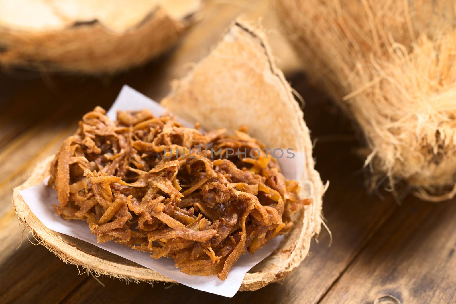 Peruvian cocada, a traditional coconut dessert sold usually on the streets, made of grated coconut and brown sugar, which gives the dark color of the sweet (Selective Focus, Focus one third ino the cocada)