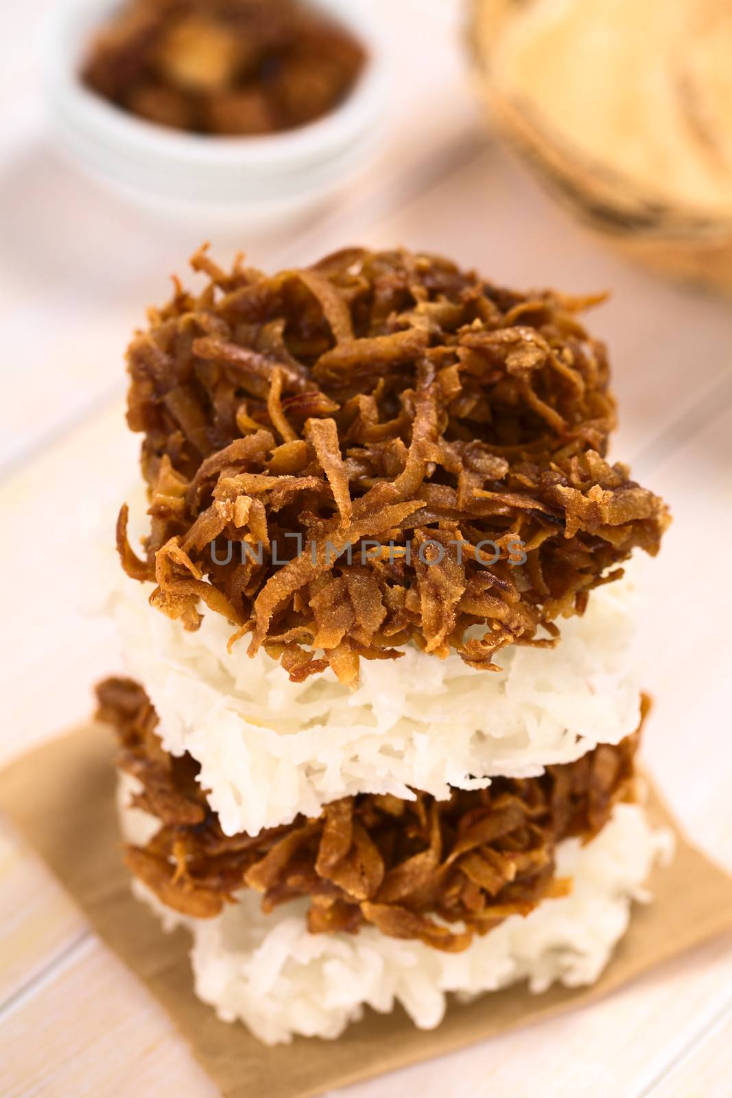 Peruvian cocadas, a traditional coconut dessert sold usually on the streets, made of grated coconut and white or brown sugar, which gives the different coloring of the sweet (Selective Focus, Focus on the front of the upper cocada)